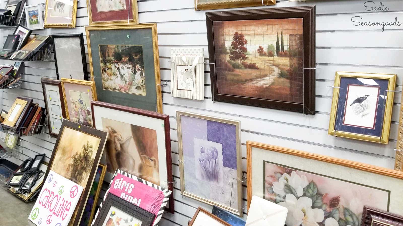 thrift store picture frames displayed on a gridwall