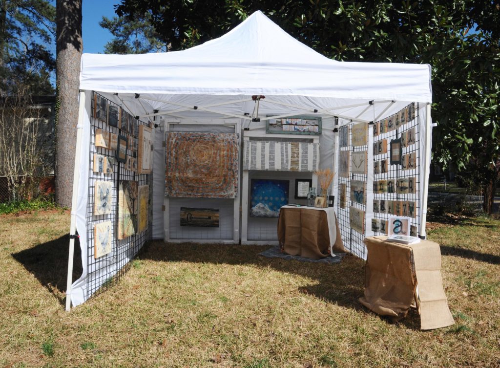 art hanging from gridwall at craft fair