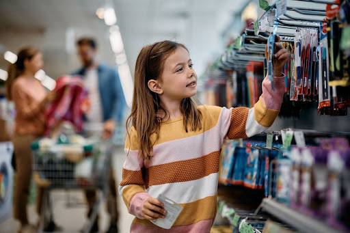child selecting product from a retail slatwall fixture