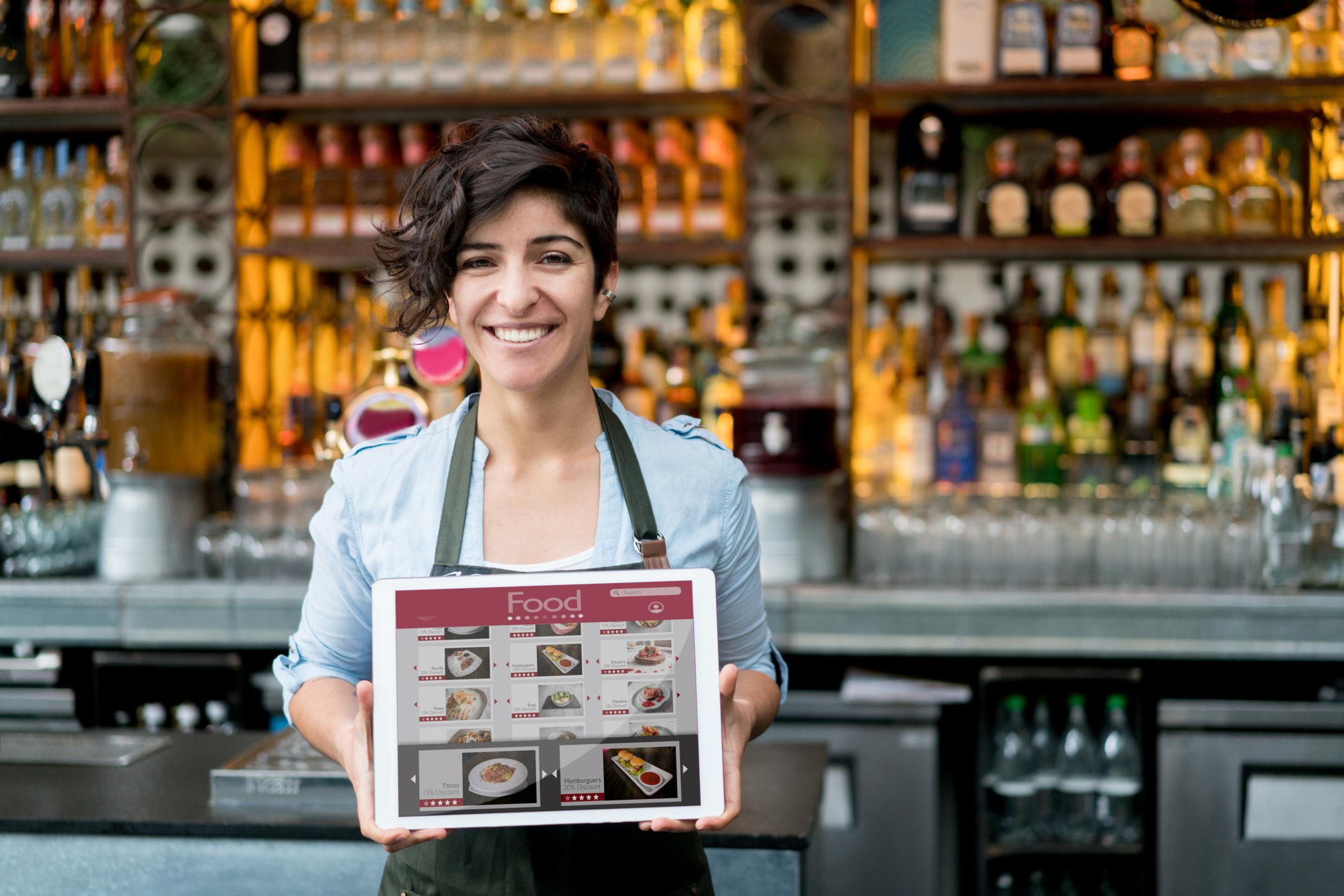 Waitress holding restaurant digital signage